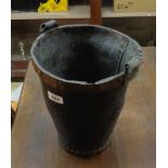 An antique copper studded leather fire bucket - handle detached but present