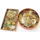 Two tins containing a large collection of assorted costume jewellery brooches - various condition
