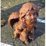 A cast iron garden angel with rusted finish