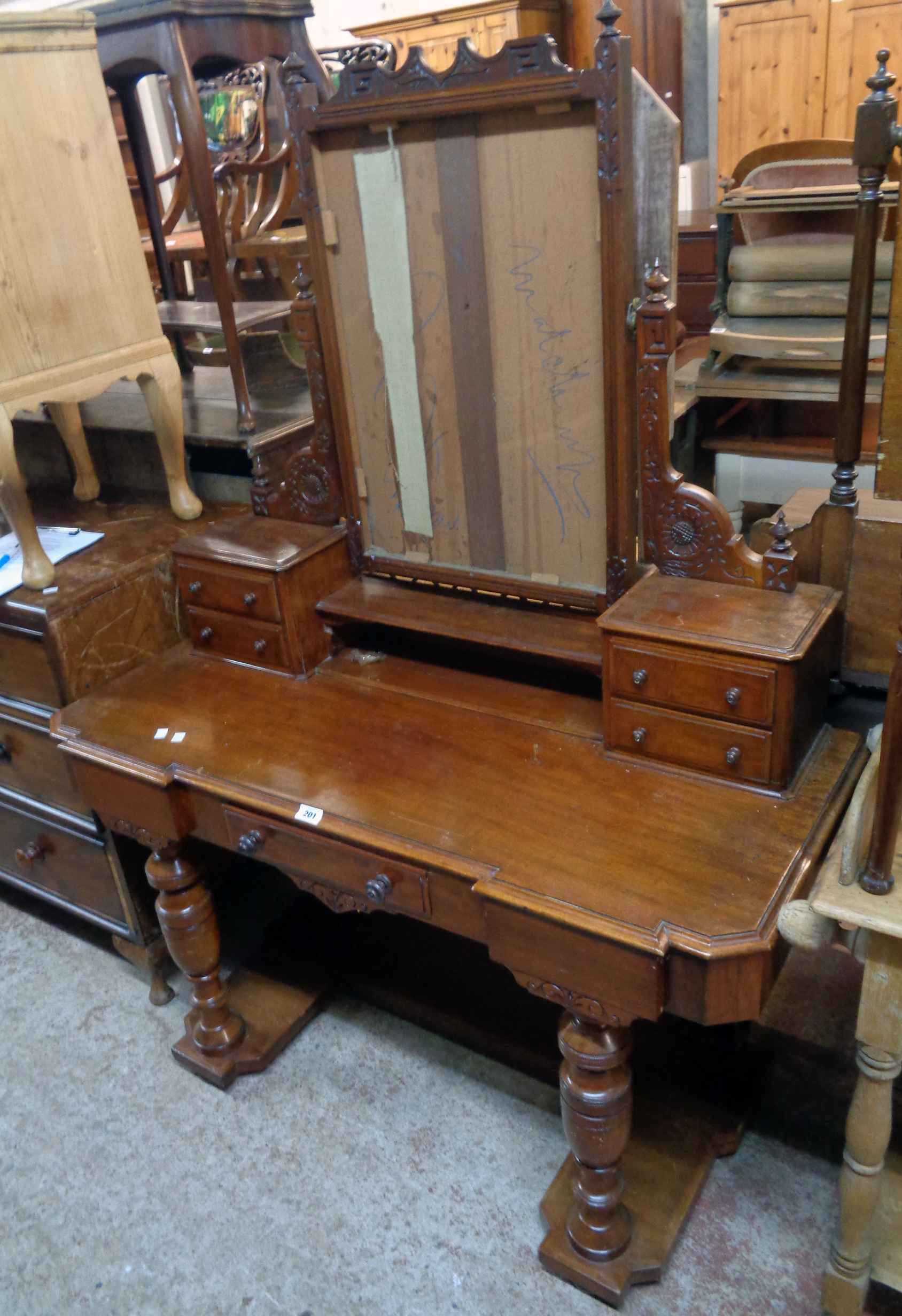 A 3' 11" Victorian mahogany dressing table with swing mirror (plate missing) and flanking trinket