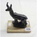 A continental Art Deco spelter model of a chamois, set on a marble base inscribed Genissiat