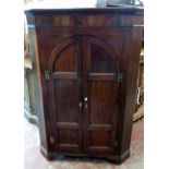 A 3' 2" 19th Century mahogany free-standing corner cupboard with canted sides, scallop shelves and