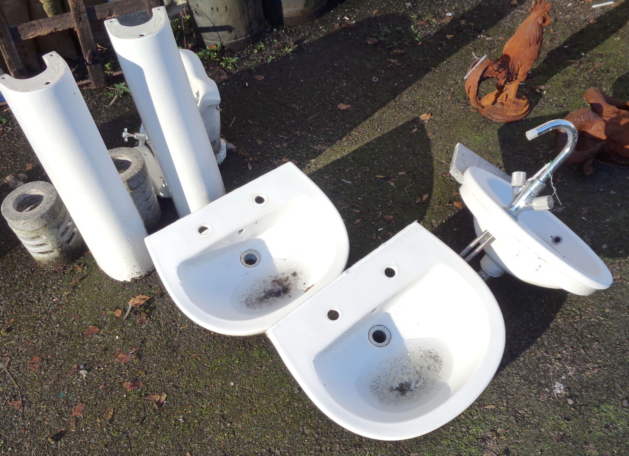 Four sinks including two pedestals and one vintage corner