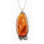 A 3 1/2" white metal mounted large composite amber cabochon, on marked 925 box-link chain