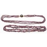 A rose metal three strand garnet bead necklace with dark faceted stone to clasp - sold with a string