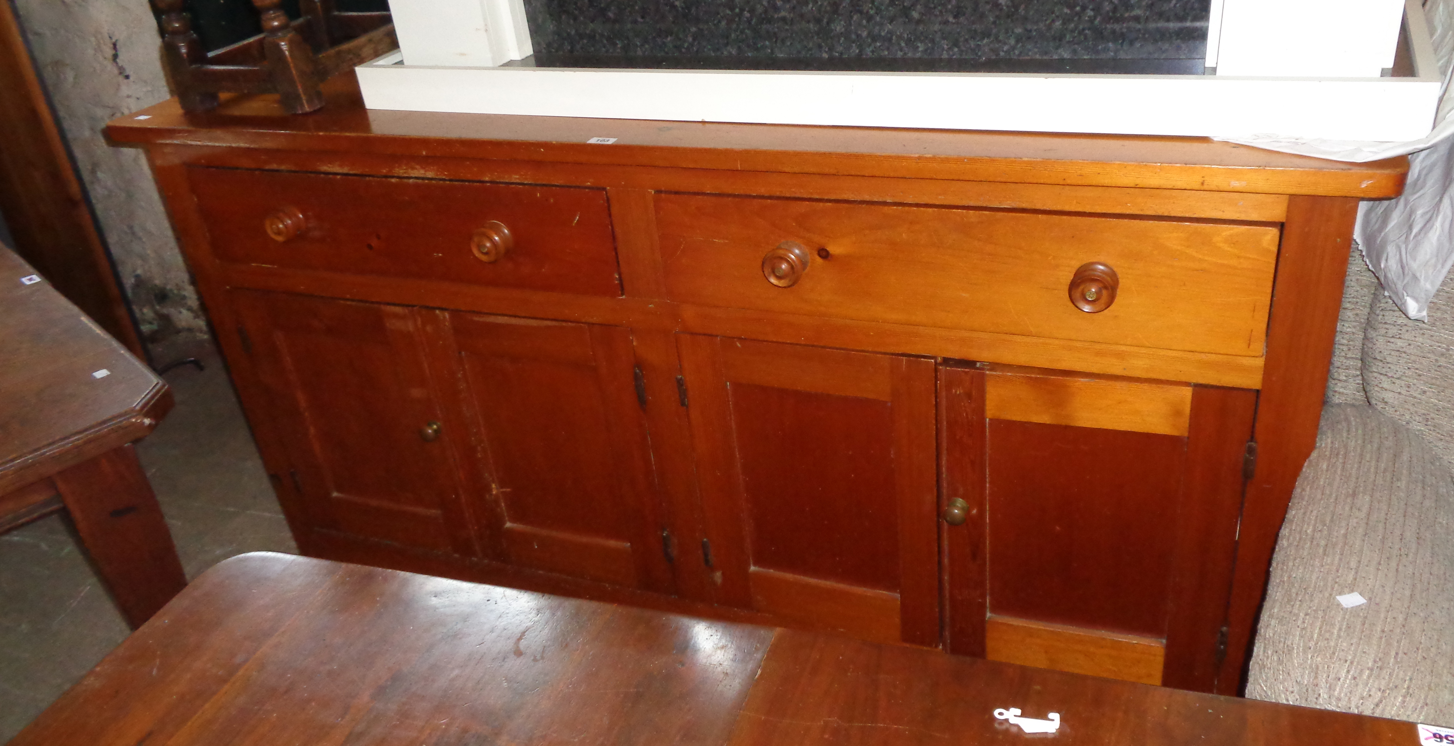 A 6' 3" Victorian polished pine dresser base with two frieze drawers and two pairs of panelled