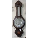 A 20th Century stained oak cased banjo barometer/thermometer with moulded decoration and aneroid