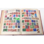 A 20th Century schoolboy stamp album containing a collection of hinge mounted world stamps