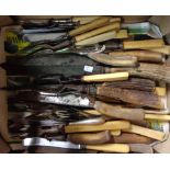 A quantity of assorted horn handled cutlery
