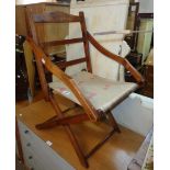 A 19th Century stained beech framed campaign style folding chair with slung upholstered seat