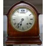 An early 20th Century polished walnut cased mitre shaped mantel clock with silvered dial and
