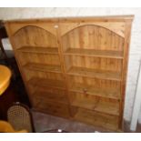 A 6' 8 1/2" 20th Century waxed pine two section side-by-side five shelf open bookcase with arcaded