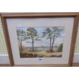 V.M.W.: a framed watercolour depicting a beach scene with trees and rocks - signed