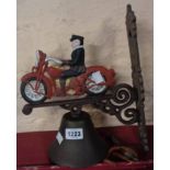 A painted cast iron porch bell with motorcycle pattern top