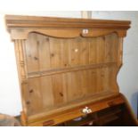 A 3' 1" 20th Century waxed pine wall mounted two shelf open plate rack with moulded decoration