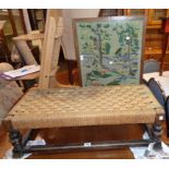 An antique stained oak duet footstool with woven string top and turned supports - sold with a