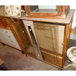 A 36" vintage mixed material display cabinet with mirror panel to front and two sliding glass doors,