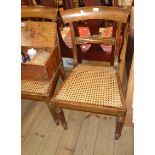 A set of six late Regency mahogany framed dining chairs with curved top rails and rattan panel seat,