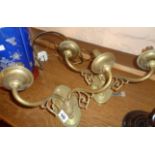 A pair of brass twin branch wall sconces