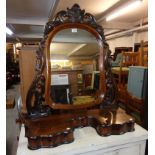 A 34" late 19th Century stained mixed wood dressing table mirror with shaped plate, pierced acanthus