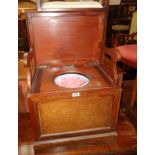 An Edwardian mahogany and strung lift-top box commode with folding armrests