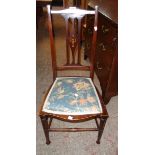 An Art Nouveau inlaid walnut framed bedroom chair with upholstered seat panel