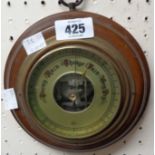 A 20th Century polished wood framed sedan style small aneroid wall barometer with visible works to