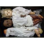 A crate containing four vintage dolls