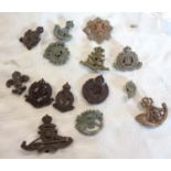 Fourteen British Army bakelite economy cap badges including Royal Scots, Military Police, Royal