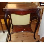 A 24" Edwardian stained mahogany swivel top card table with serpentine edge and shaped undertier,