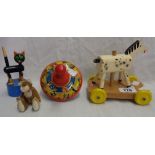 A vintage tin plate humming spinning top, two vintage wooden toys, and a felt cat