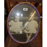 A 1920`s giltwood and purple sponged effect oval picture frame