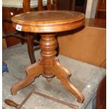 A Victorian stained oak revolving piano stool with tooled leather inset top, metal screw action