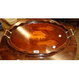 A 22 1/2" reproduction inlaid mixed wood serving tray with central shell motif, wavy gallery and