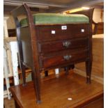 An early 20th Century stained wood locker piano stool with upholstered seat and two long drop-