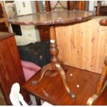 A 28" diameter mahogany pedestal table in the Georgian style with pie-crust top, set on turned