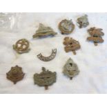 A collection of British Army infantry cap badges including Royal Berkshire Regiment, The Buffs,