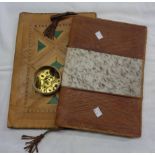 Two leather writing cases with tribal decoration - sold with a quantity of brass monogram buttons