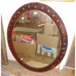 A 3' 6" late Victorian velvet framed oval wall mirror with applied Gothic cross studded decoration