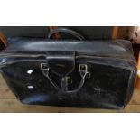 A vintage black Gucci soft leather suitcase