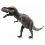 A bronzed Tyrannosaurus Rex dinosaur figure