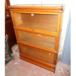 A 34" early 20th Century polished oak Globe Wernicke three section elastic bookcase with cornice and