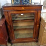 A 29 1/2" late Victorian inlaid walnut pier cabinet with material lined shelves enclosed by a glazed