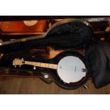 A Plucky Tonewood banjeurine banjo with associated hard case and soft gig bag