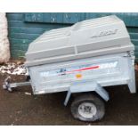 An Erde 122 trailer, with lift up cover
