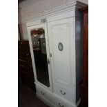A 4' 3" old French style painted wardrobe with cut cornice, applied jasperware panels and swag