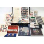 A box file containing mint decimal stamp packs, a small stock book, other world stamps hinge mounted