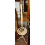 A low painted wood standard lamp/wine table, set on turned pillar and tripod base