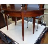A 4' antique mahogany demi-lune side table with stringing to apron edge, set on square tapered