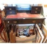 A 36" late Victorian ebonised writing table with flanking raised double drawers and tooled red